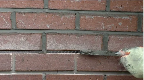 Repointing work in a cracked brick wall