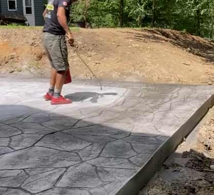 Applying seal coat for stamped concrete